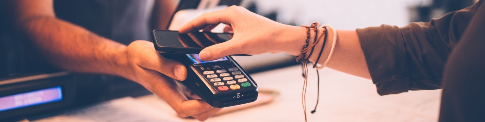 Woman making a payment with her mobile device